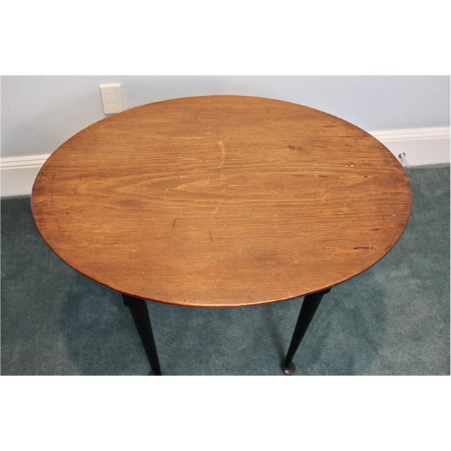Vintage Queen Anne style side table in a warm, weathered pine finish with an oval top, black painted base, shaped skirt...