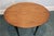Vintage Queen Anne style side table in a warm, weathered pine finish with an oval top, black painted base, shaped skirt...