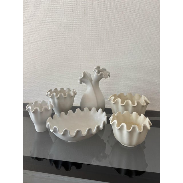 A set of six pieces (vases and bowls) from the “Våga” pattern, designed by Wilhelm Kåge for Gustavsberg in the late 1940s....