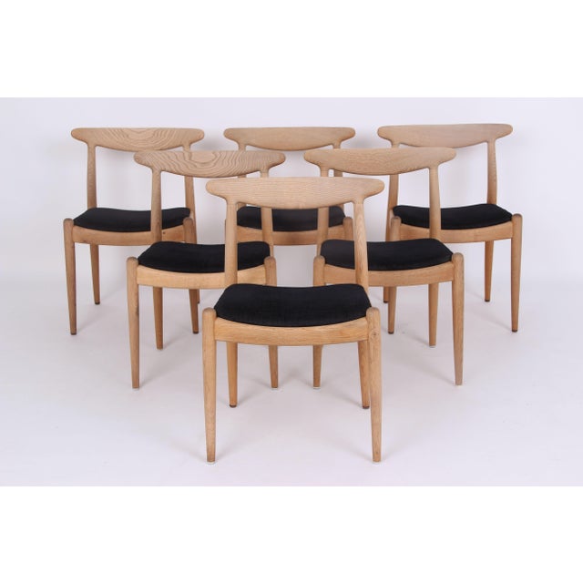 Six beautiful wegner classics in light oak, upholstered in anthracite gray fabric. The chairs are in very good original...