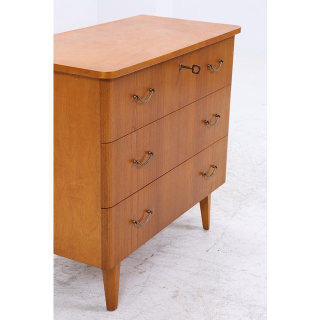 Original vintage chest of drawers in a mid-century design with clean lines and a timeless appeal. Multiple drawers offer...