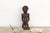 Carved standing figures like this one were never meant to represent one specific person, they're built to hold a presence,...