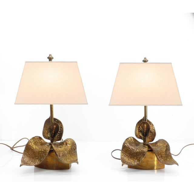 Pair of French table or bedside lamps made of hammered and patinated brass, in an organic style typical of 1970s...