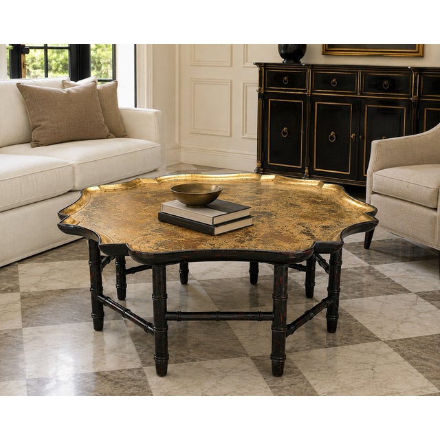A striking vintage Kittinger octagonal cocktail table featuring an original distressed gold-leaf tray-style top over a...