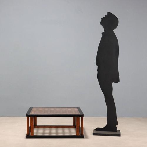 Elegant coffee table with ebony-stained wood base, top featuring woven stained larch slats, and clear glass top. Very good...