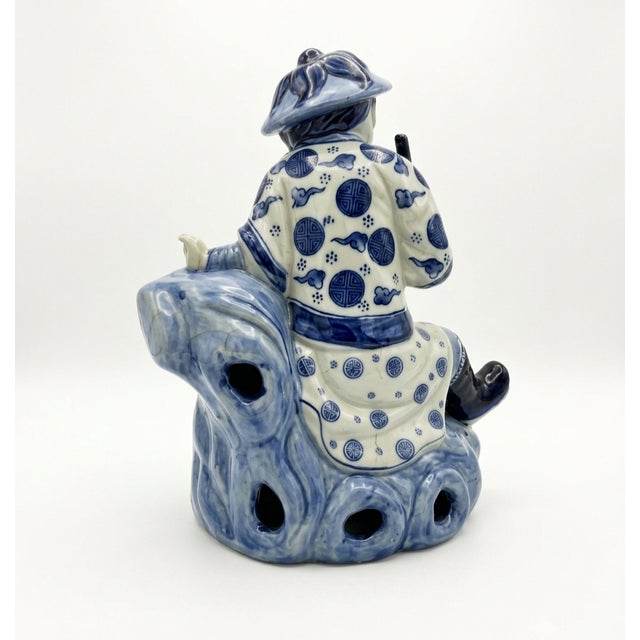 Add classic Chinoiserie elegance to your space with this captivating vintage blue and white glazed porcelain statue. This...
