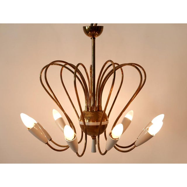 Extremely rare, lovely and highly decorative mid-century modern nine-flamed sputnik pendant lamp or chandelier. Designed...