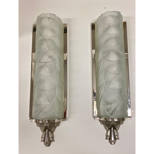 Grand pair of French Art Deco wall sconces by the French artist “Degue”. Having clear frosted glass shades with geometric...
