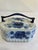 A charming blue and white lidded box with cobalt roses and leaves on the sides and lid, topped by a deep blue arched...