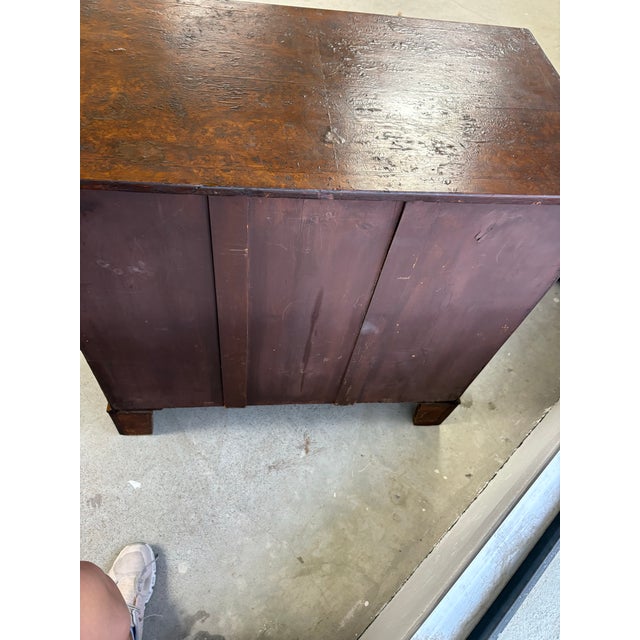 A handsome 19th-century English chest of drawers, beautifully veneered in richly figured burr walnut with warm mahogany...