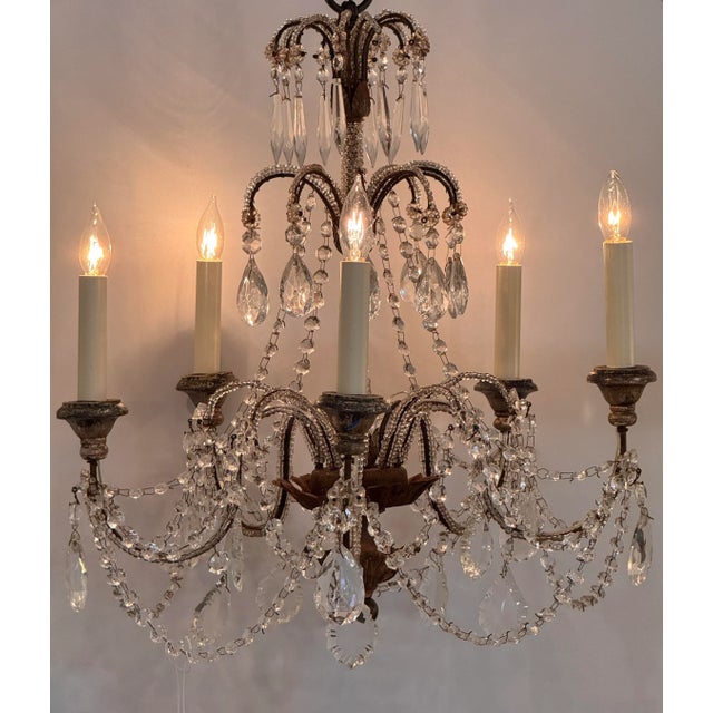 Six-light Italian chandelier with a beaded metal frame and swags of faceted crystal garlands. Decorative teardrop prisms...