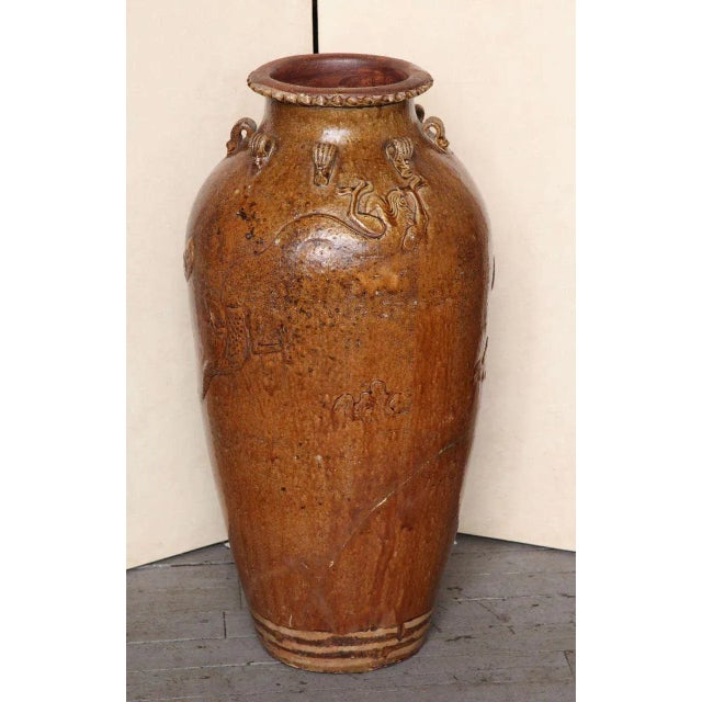 A Ming dynasty Martaban jar from the 15th-16th century. This tall Chinese jar comes from the Martaban wares, where it was...