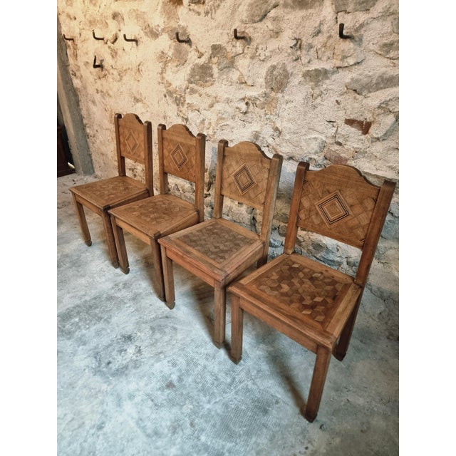 Beautiful set of 4 antique dining chairs crafted from solid walnut, featuring intricate geometric inlay in solid wood on...