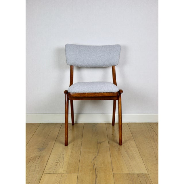 Skoczek chair in light blue and light grey boucle fabric from the 1970s. A fully restored Polish vintage springer chair...