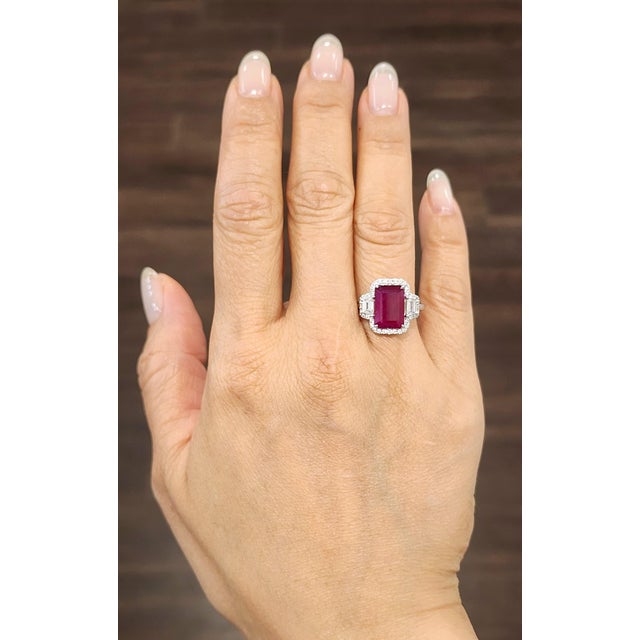 This exquisite certified ruby and natural diamond ring is a captivating piece of modern jewelry, crafted in lustrous 14k...