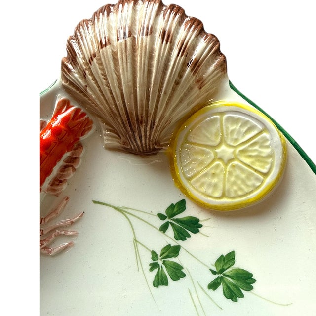 An elegant Italian hand-made ceramic serving platter, measuring approximately 11¼ inches long, featuring sculptural...