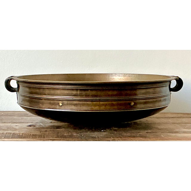 This monumental vintage Urli bowl is a masterful example of traditional Indian metalwork, blending rustic texture with a...