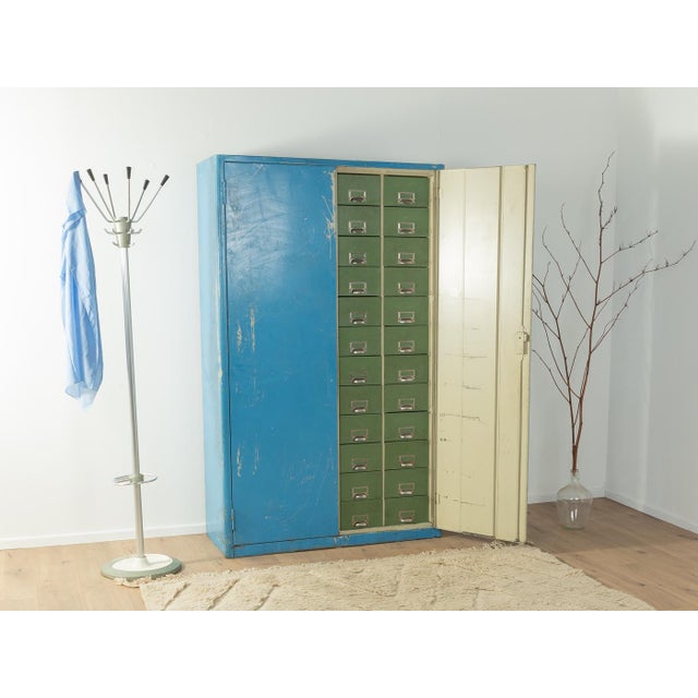 Unique steel cabinet from the 1950s. High-quality blue lacquered body with 48 green drawers. The cabinet was cleaned and...