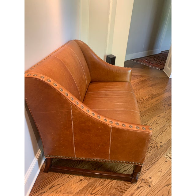 Leather Cognac colored grade E Gourmet G304 cognac leather Settee by WS. Beautiful barely twisted legs with standard nail...