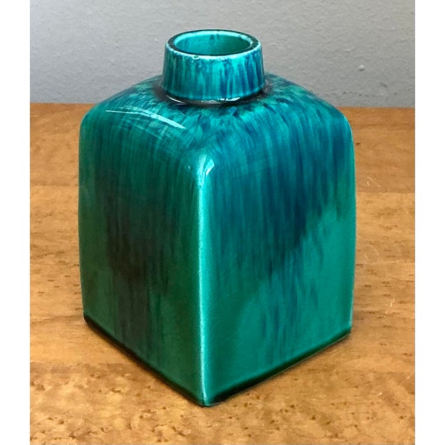 This striking Italian ceramic vase is a vibrant example of Mid-Century Modern design, featuring a bold architectural...