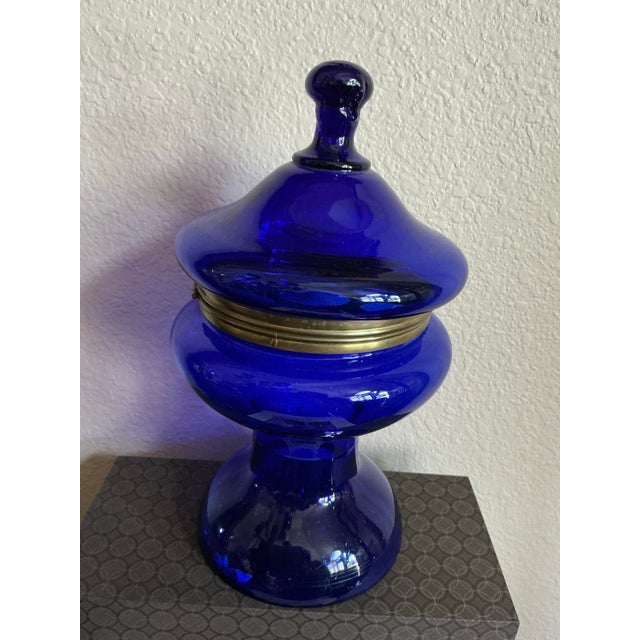 A striking cobalt blown glass decanter/flower frog with original pierced metal lid, showcasing the bold color and...