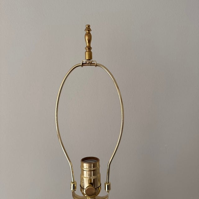 Unique mid-century era lamp features a pink floral toile style pattern throughout the ceramic base with gold accents. It...