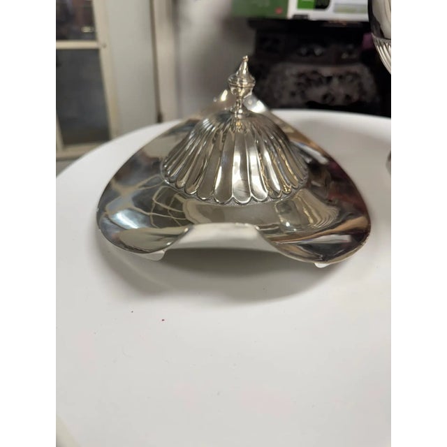 This large sterling silver soup tureen features a classic Art Deco influence, noted in its fluted scallop pattern along...