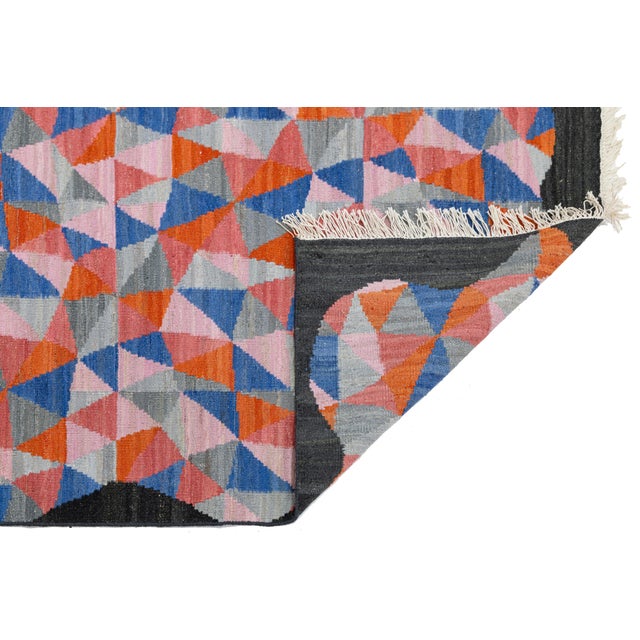 Laura Gottwald's Apadana Collection Fantasia features an exuberant design of asymmetrical triangles in vibrant colors....