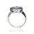 A refined mid-century platinum ring featuring a central emerald-cut, approximately 5-carat pastel blue sapphire. The...