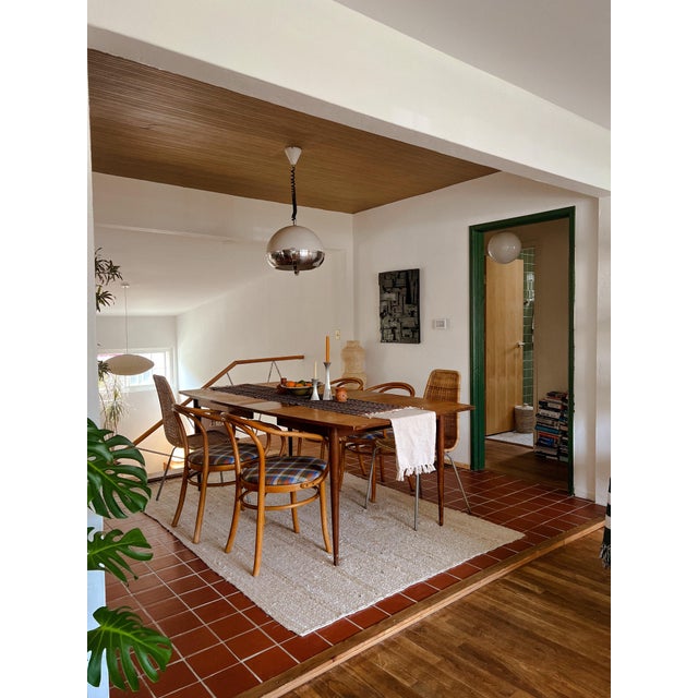 A beautifully proportioned mid-century modern dining table, attributed to Broyhill’s “Emphasis” line, circa 1960s. Crafted...