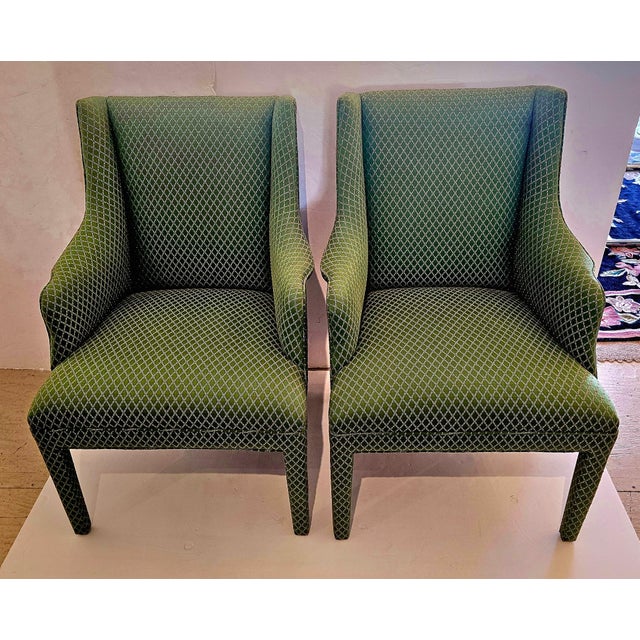 Sophisticated pair of tailored upholstered straight back club chairs having a lovely green fabric covering everywhere...