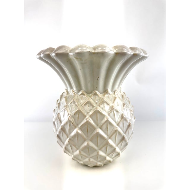 A charming vintage ceramic vase modeled in the form of a pineapple, finished in a soft creamy white glaze with subtle...