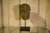 A stone architectural mascaron head in the Renaissance/Neo-Renaissance style, mounted on a contemporary metal base. The...