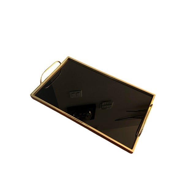 We have for your consideration a very beautiful brass plated serving tray. Serving tray consists of black glass center...