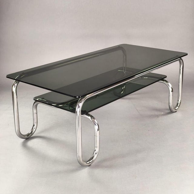Italian-design coffee table from the 1970s, featuring a tubular chromed steel frame with rounded, typically Space Age...