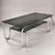 Italian-design coffee table from the 1970s, featuring a tubular chromed steel frame with rounded, typically Space Age...
