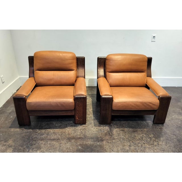Unique, high-quality circa 1970 French manufacture club chairs. Richly veined, heavy oak wood frame with rich, tufted...