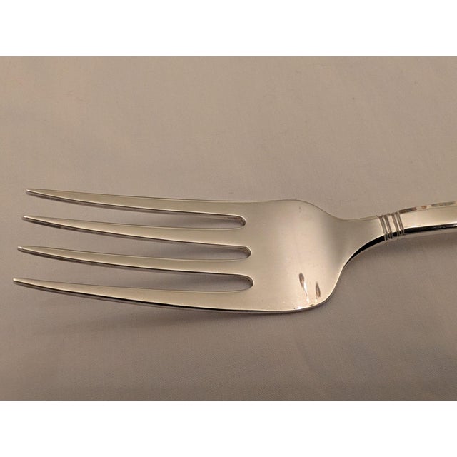 A sterling silver Tiffany serving/salad/cold meat fork in the sophisticated "Windham" pattern. This pattern combines...