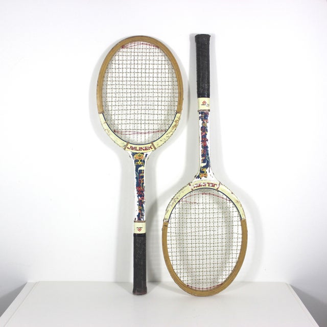 Pair of Vintage wooden tennis racquets for designer decorating. These are wood with leather grips. These have great patina...