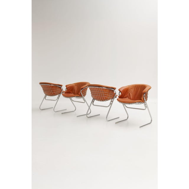 Flynn dining chair designed by Gastone Rinaldi and produced by Thema. Chromed metal mesh frame with a brown leather seat...