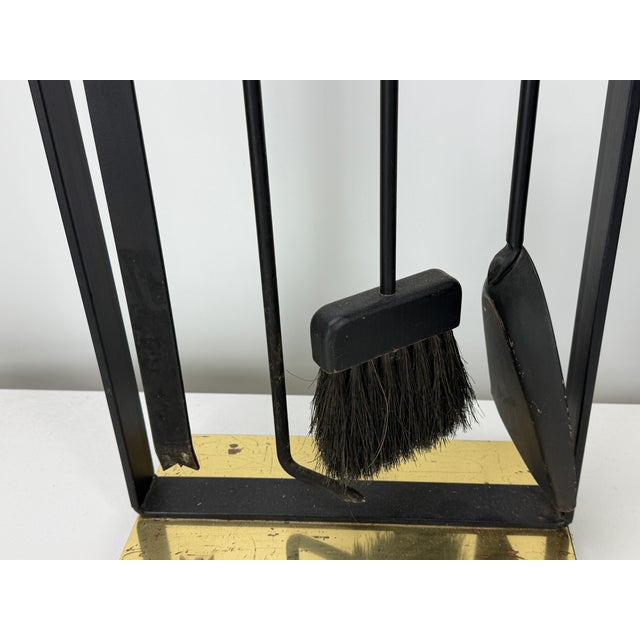 Styled after Pilgrim Fireplace tool set. Set of four fireplace tools with stand in wrought iron with brass accented base...