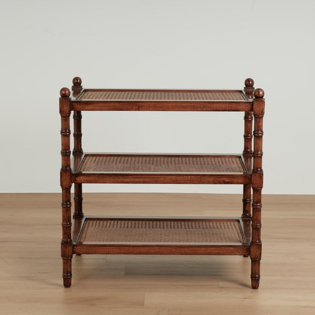 Handsome vintage British colonial style stand crafted in mahogany with three caned tiers on classic turned supports.