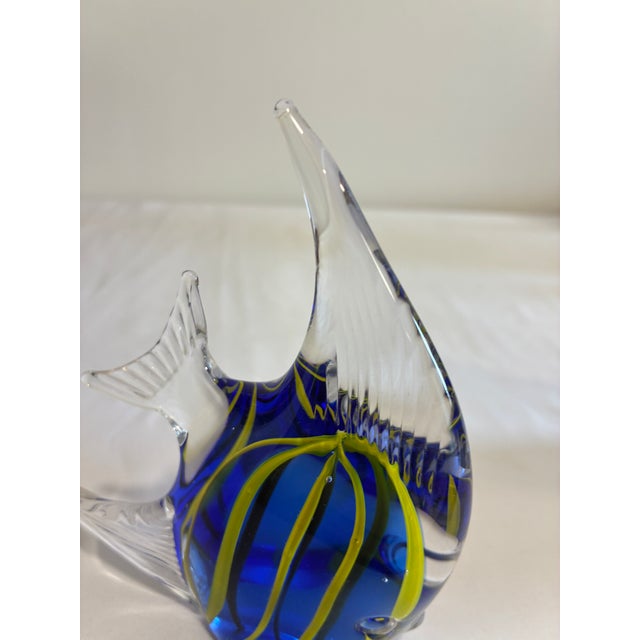 Vibrant vintage art glass fish figurine featuring a cobalt blue body with swirling chartreuse green and black stripes....