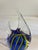 Vibrant vintage art glass fish figurine featuring a cobalt blue body with swirling chartreuse green and black stripes....