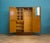 1930s oak compactum with bold geometric veneer and original brass handles. Fitted interior: hanging rail to the right; to...