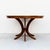 A beautifully refinished expandable walnut dining table with two leaf extensions from the 1960s. The tabletop rests atop...