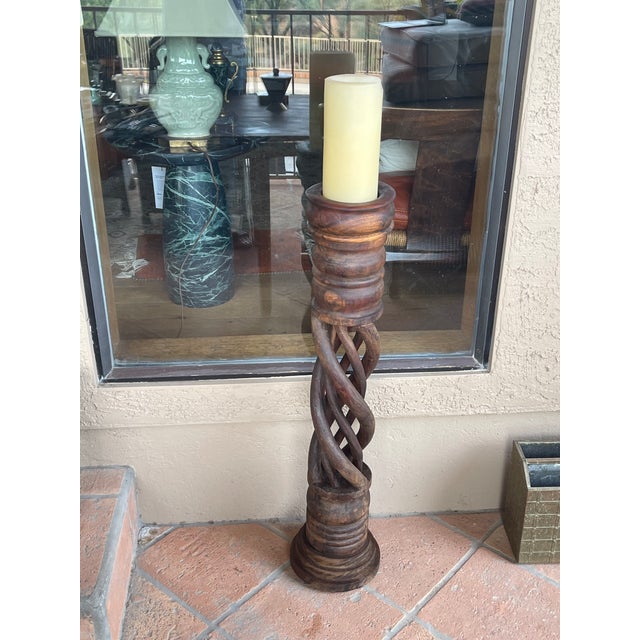 Here us a rustic farmhouse carved hard wood barley twist floor candle stand. A 4" wide candle will fit inside a 4.5" top....