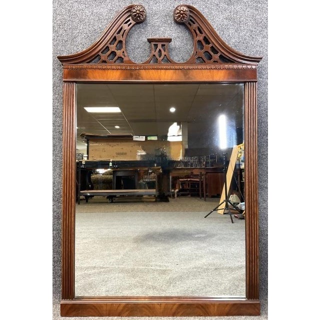 A vintage mahogany Georgian Revival wall mirror crowned with a carved plume crest. At 28 by 42 inches, it's a substantial...
