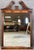 A vintage mahogany Georgian Revival wall mirror crowned with a carved plume crest. At 28 by 42 inches, it's a substantial...