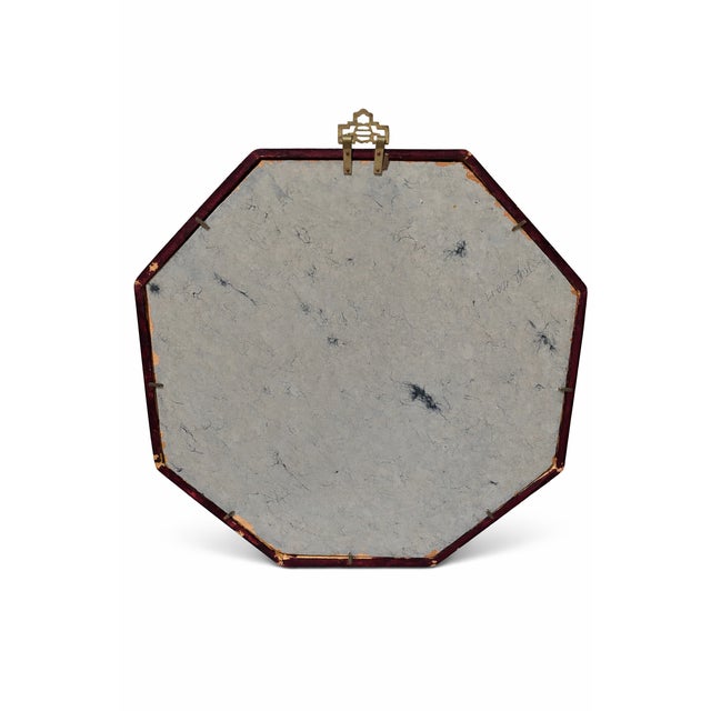 A refined mid-century decorative mirror featuring an octagonal painted wood frame adorned with floral blossoms and birds...